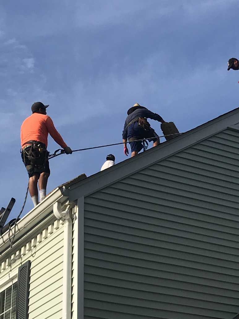 Three Franklin roofers completing a roof replacement project