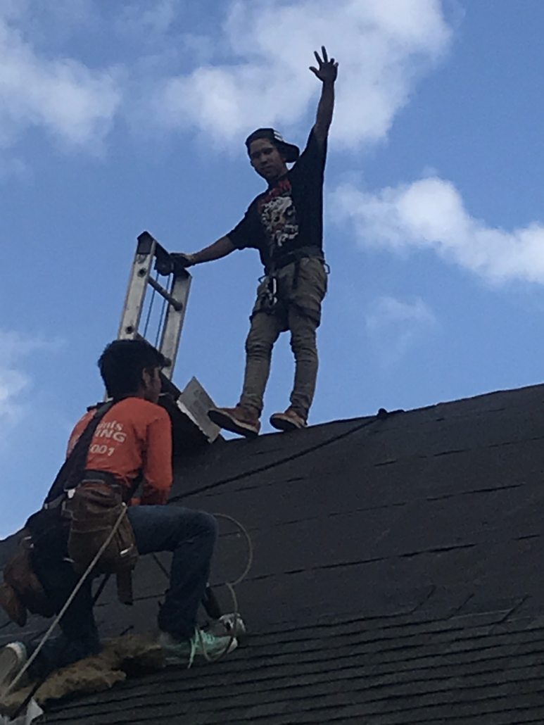 Two roofers from Five Points Roofing Company installing a new roof