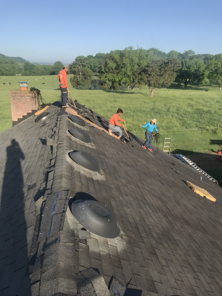 Three roofers from Five Points Roofing Company working on a roof in Middle Tennessee