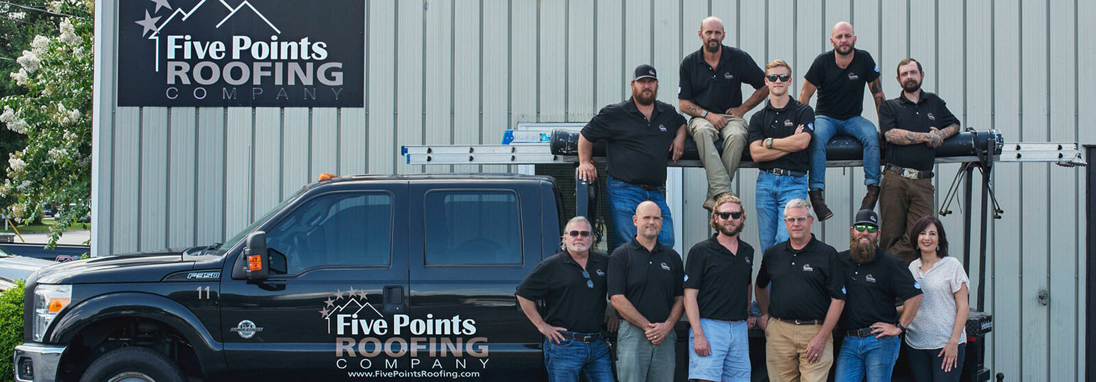 Five Points Roofing Company team photo in front of company truck