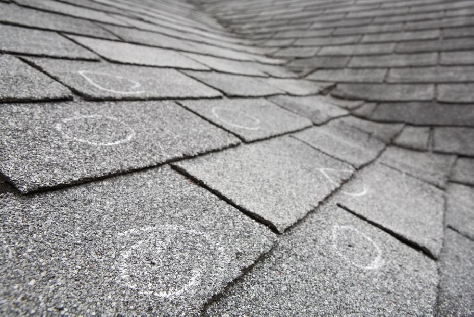 Shingle roof with circles identifying problem areas from roof inspection