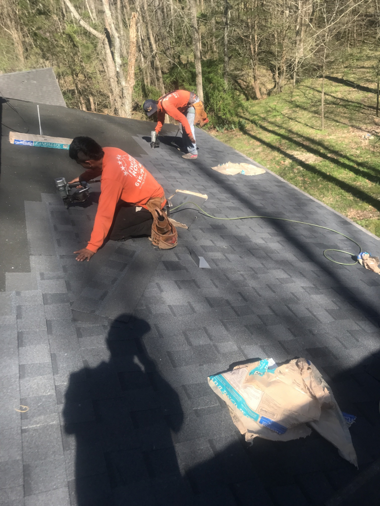 Two roofers in Hendersonville, TN working on a roof replacement