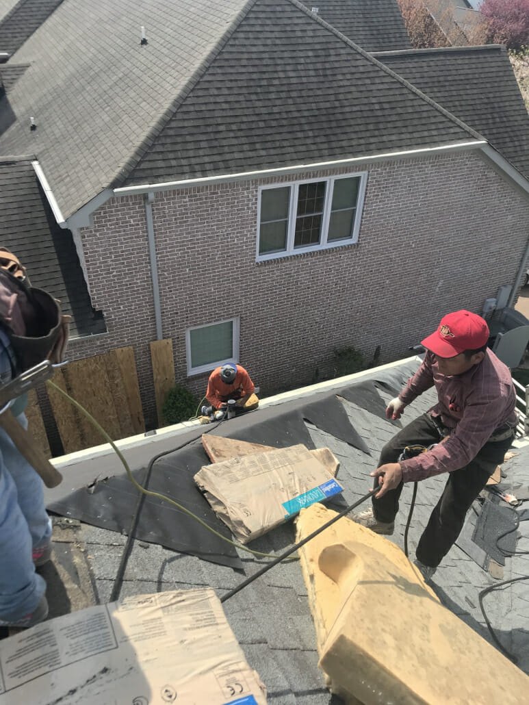 Three roofers in Spring Hill, TN completing a roof replacement on a shingle roof