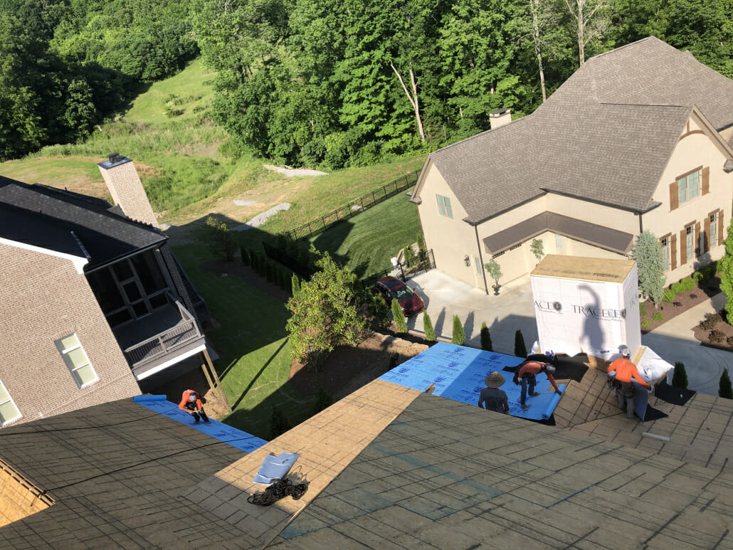 A group of roofers from Five Points Roofing Company installing a new roof