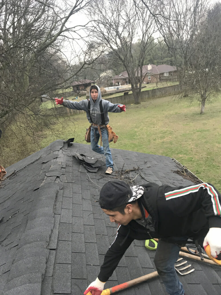 Two Spring Hill roofers replacing a shingle roof