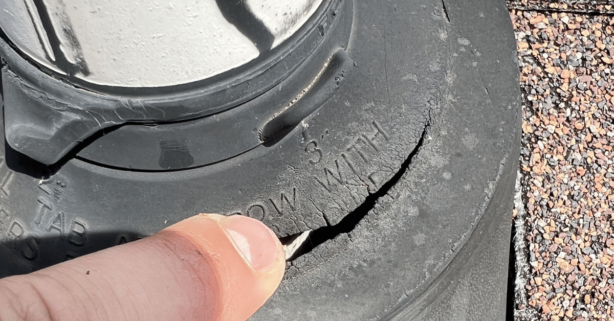 Cracked rubber seal around a roof vent, showing visible wear.