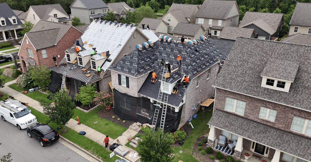 A rooftop showing missing and damaged shingles, a common issue caused by wind and harsh weather.