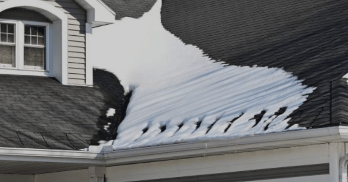 A roof showing uneven snow melt and ice buildup near the edges.