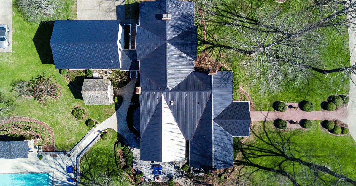 A bird's-eye view of a home with a newly installed metal roof.