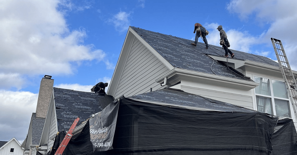 Roofing contractors installing underlayment for an asphalt shingle roof.