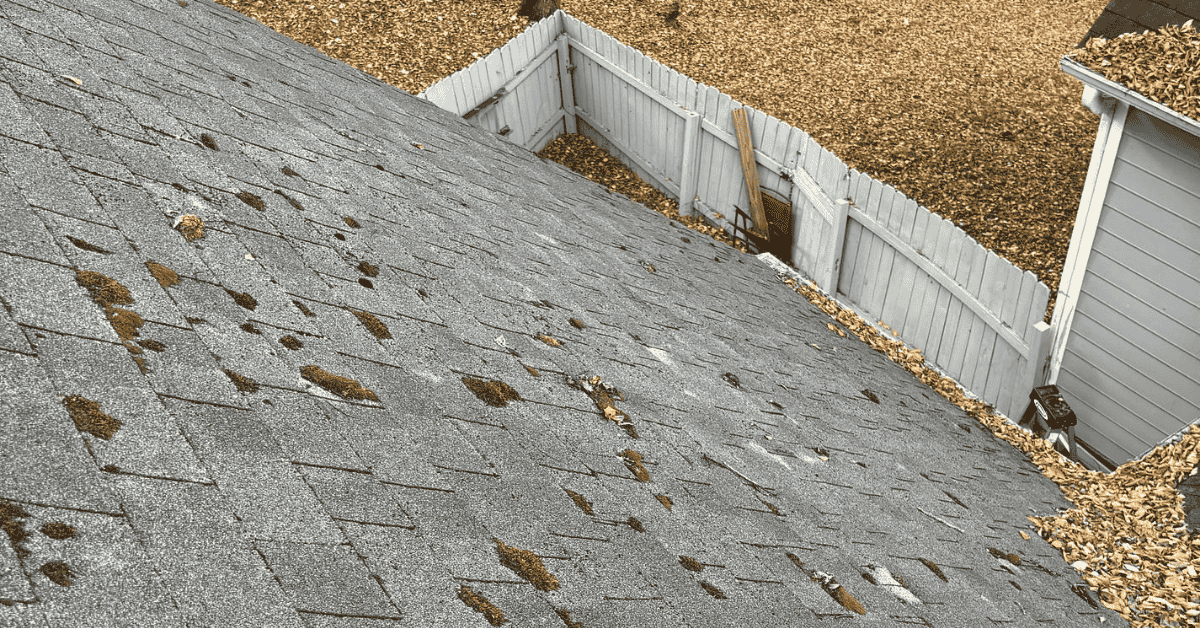 A damaged roof with visible signs of moisture and wear.