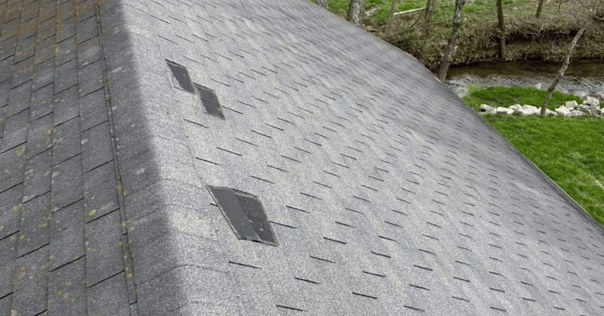 A roof showing small dents and damage patterns typical of hail impact after a storm.