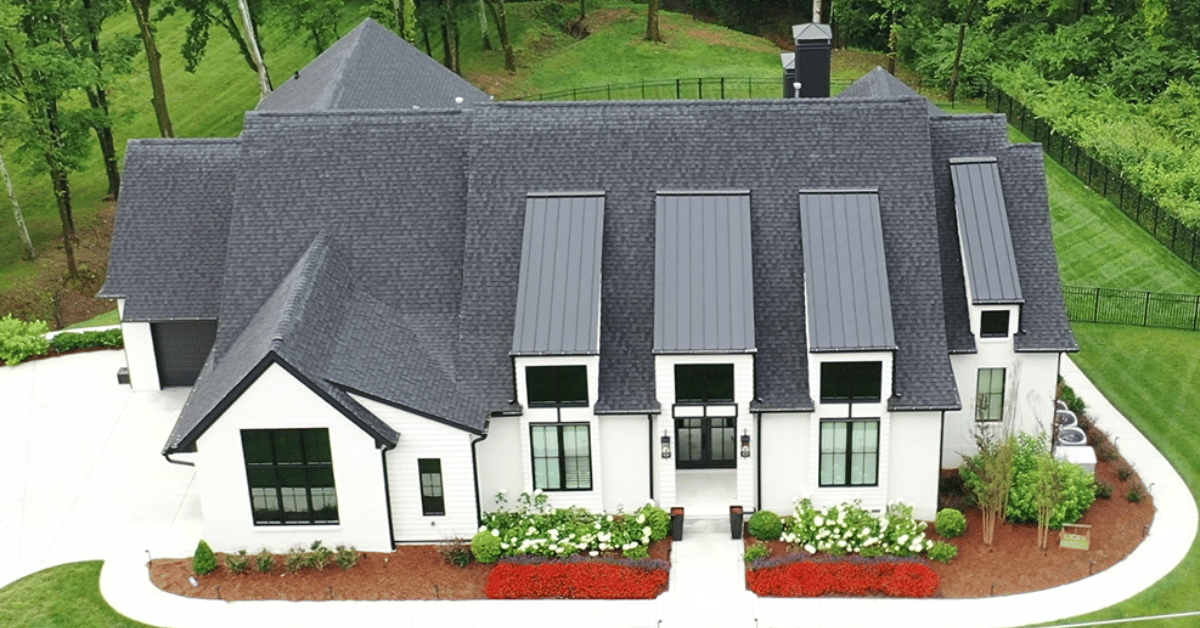 A contemporary home featuring a combination of asphalt shingles and metal roofing panels.