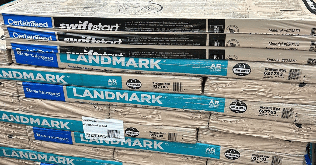 Stacks of CertainTeed roofing materials, including Landmark shingles in Weathered Wood, ready for installation.