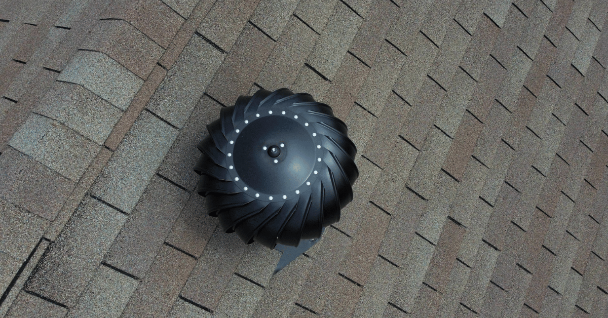 A roof with a wind turbine ventilation system installed.