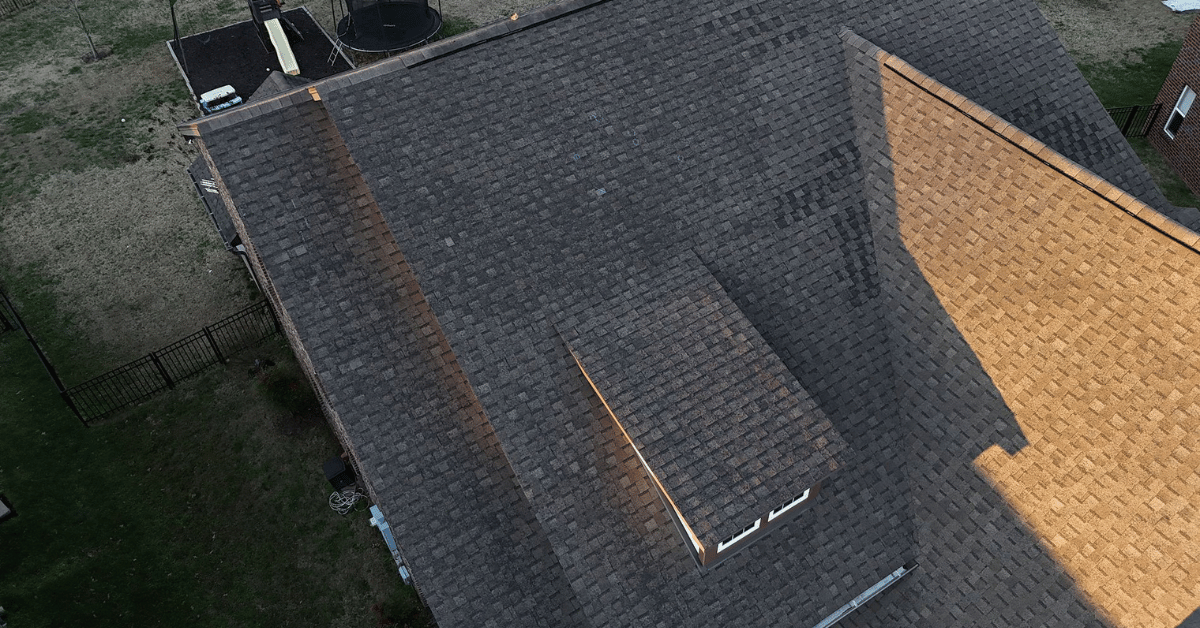 Drone view of a home’s roof showing discoloration and aging TAMKO shingles