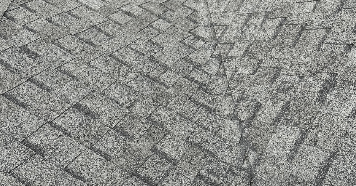 Roof valley with visible wear and improper Tamko shingle application.