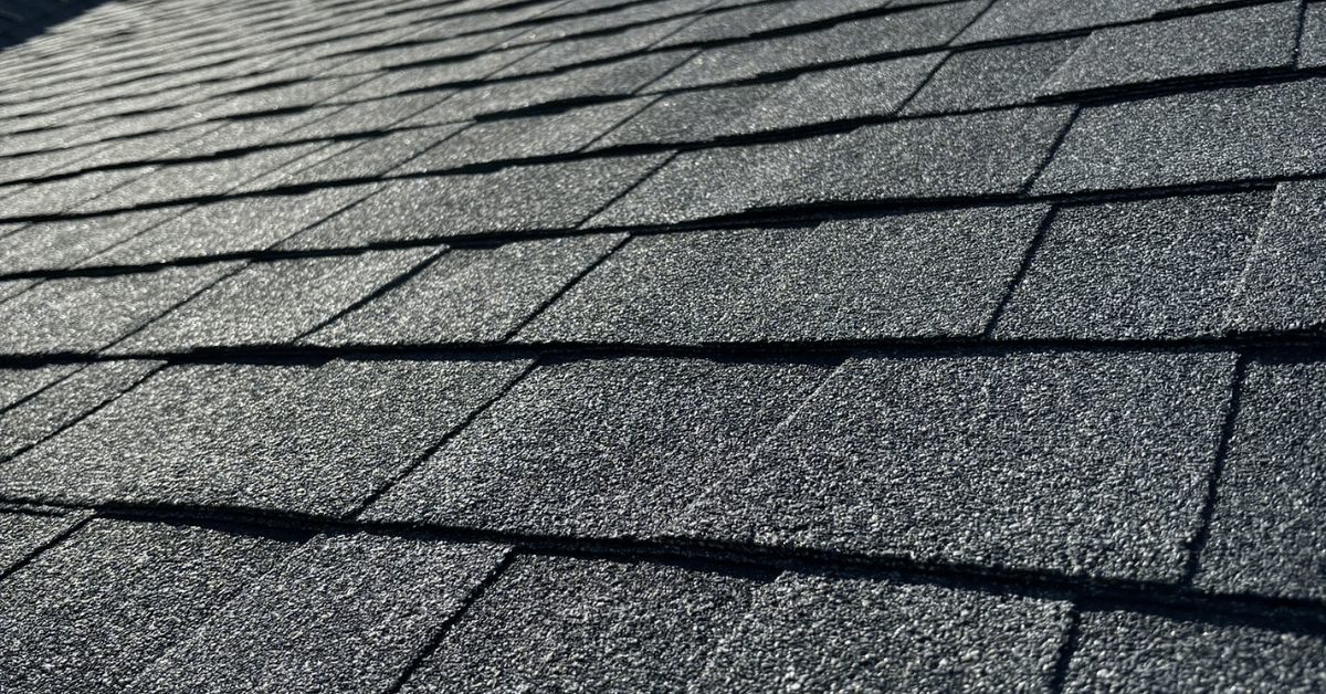 A close-up view of asphalt shingles in perfect condition.