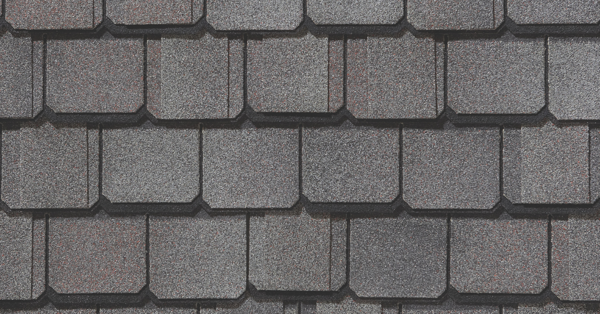 A close-up of high-end luxury asphalt shingles with a textured design and multiple color variations.