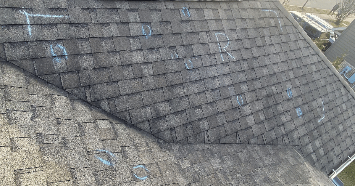 Roof with Tamko shingles marked in chalk to identify damage areas.