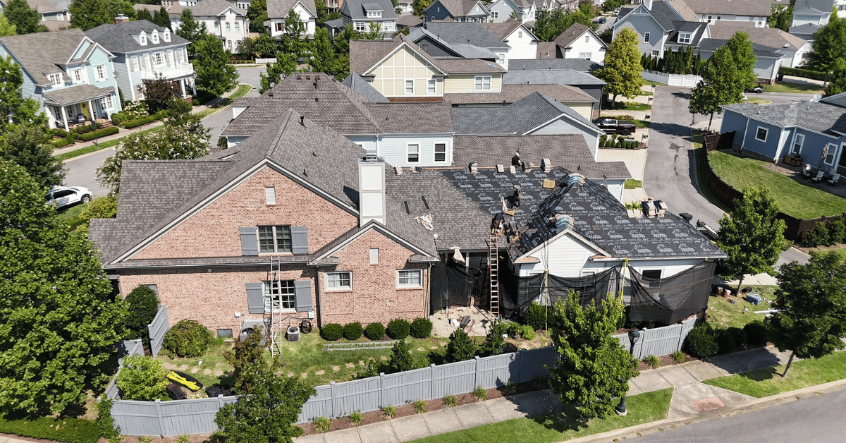 Aerial shot of a roof replacement project in a suburban neighborhood.