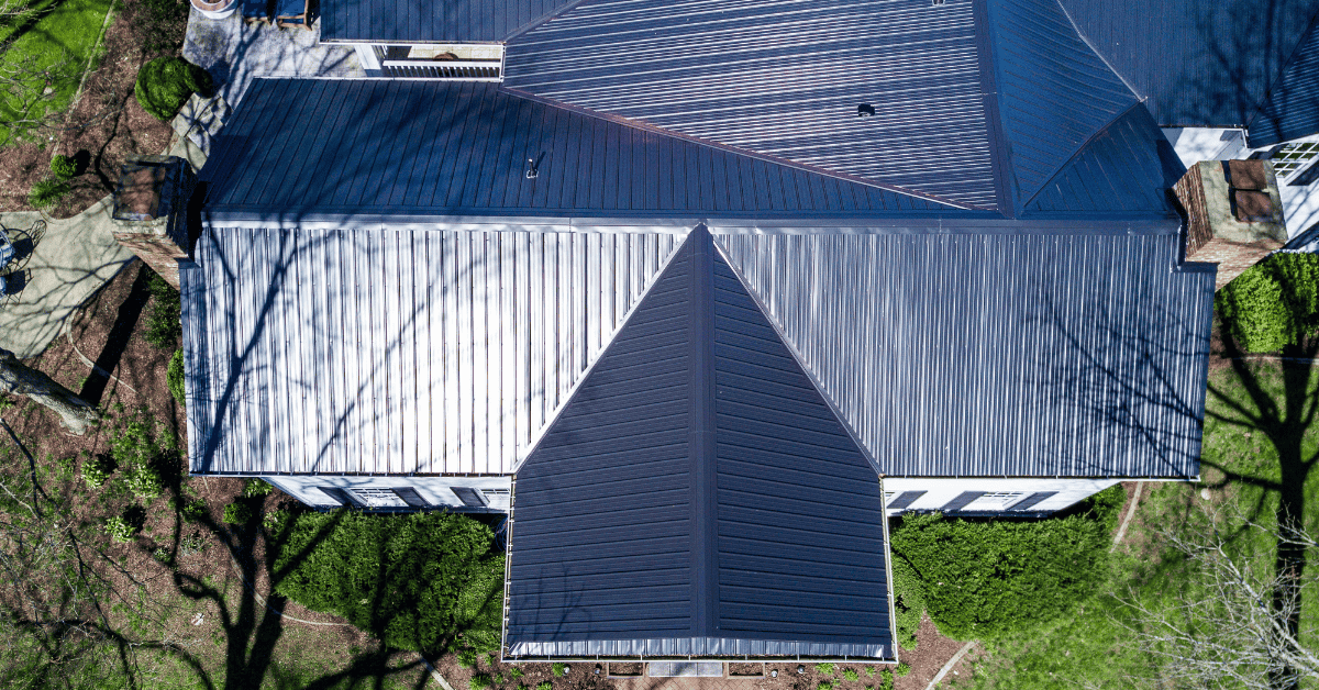 A sleek, silver standing seam metal roof with raised ridges running vertically.