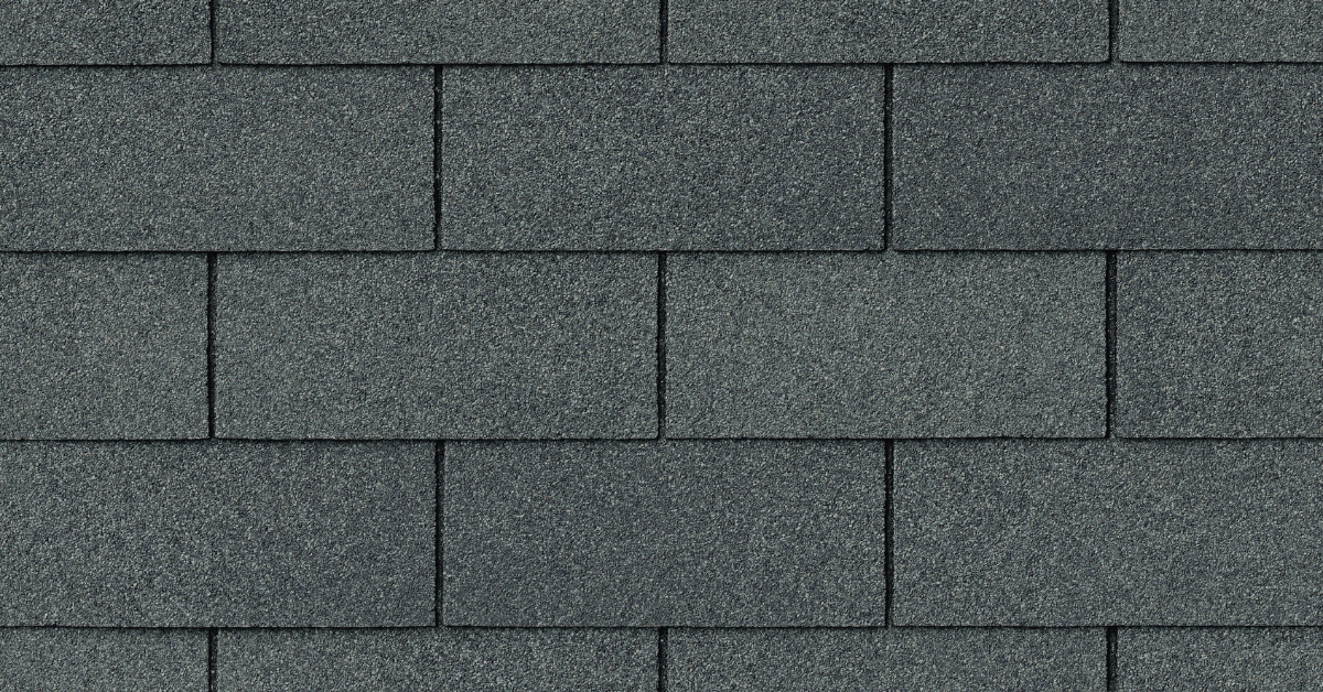 A close-up of gray three-tab asphalt shingles with a uniform, flat design.