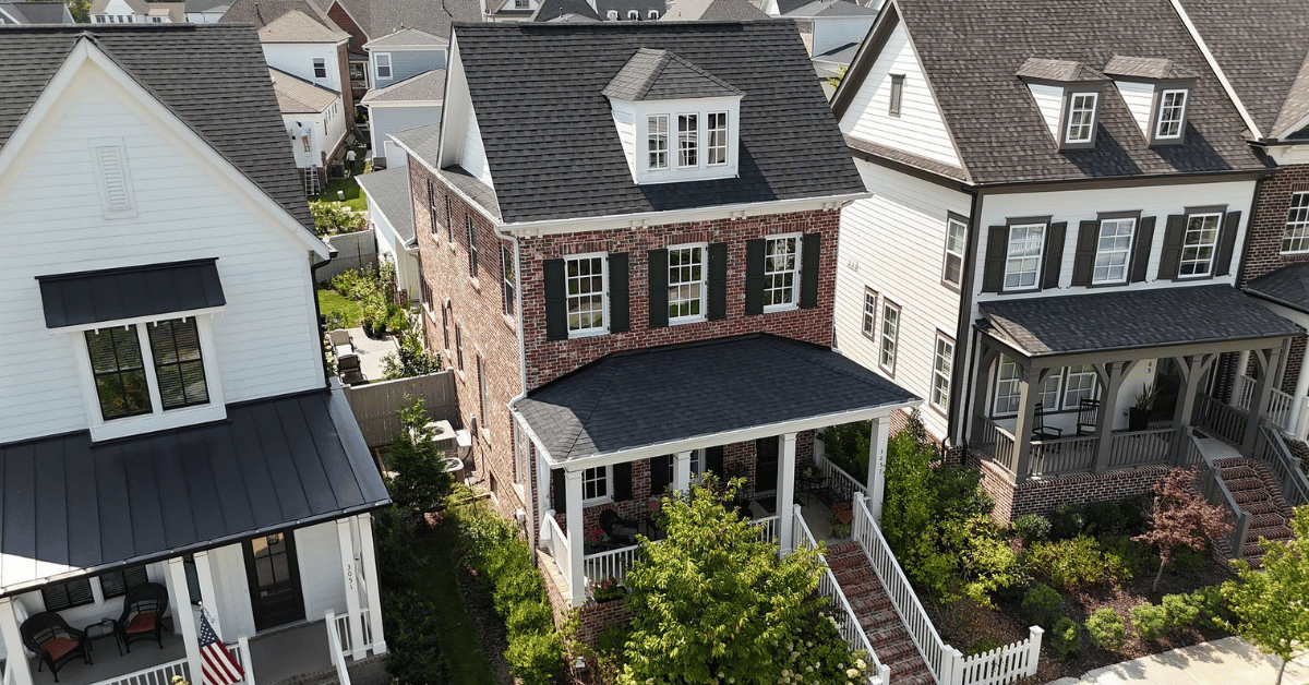 A beautiful brick home with a clean, well-kept roof in a suburban neighborhood.