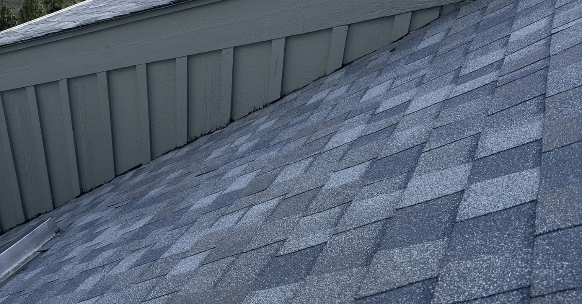 A close-up of a newly installed asphalt shingle roof with clean lines and proper sealing.