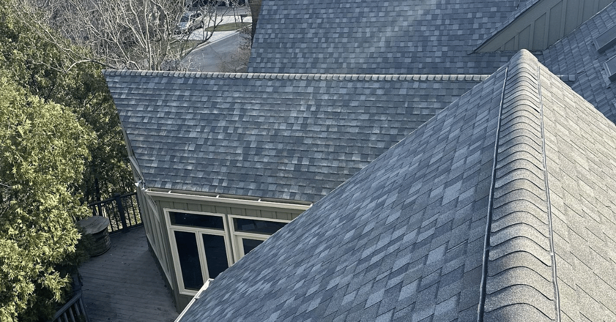 A bird's-eye view of a well-maintained asphalt shingle roof on a residential home.