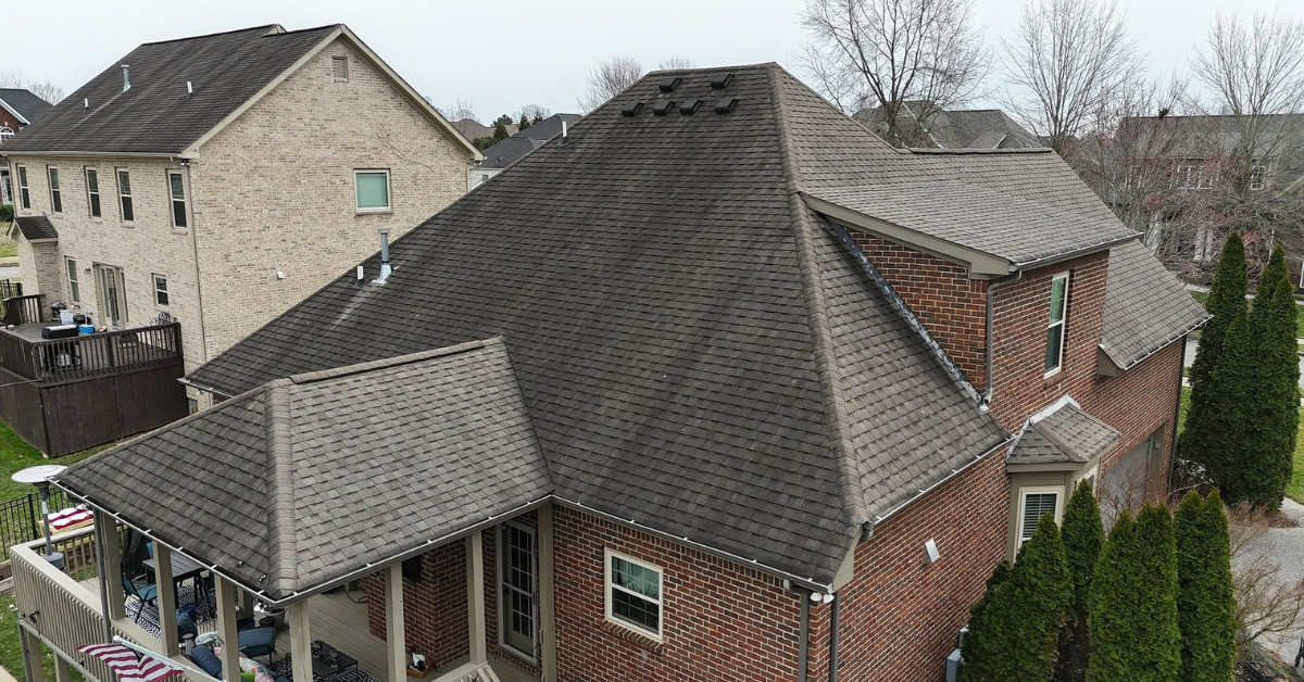 A bird's-eye view of a large Tennesse residential roof with brown shingles.