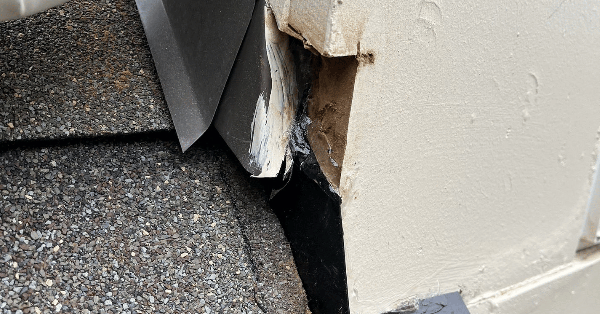Damaged or misaligned roof flashing near wall siding
