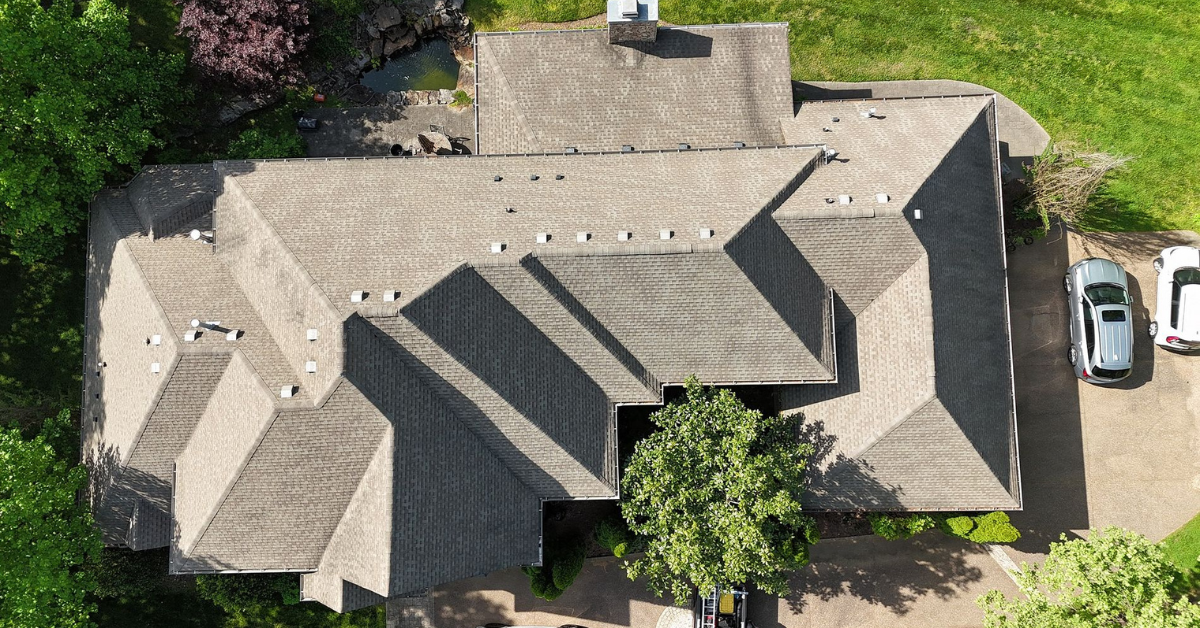 Aerial view of a newly installed roof by Five Points Roofing, showcasing high-quality craftsmanship and materials.