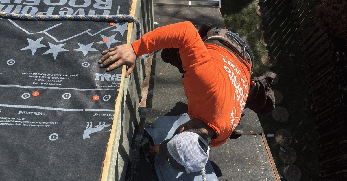 Five Points Roofing contractor installing flashing and underlayment on a roof edge