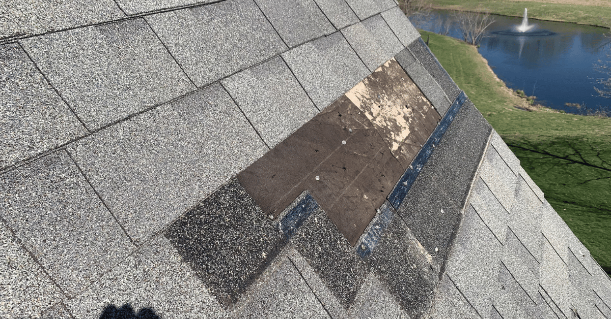 Exposed roofing underlayment and nails after shingles blew off