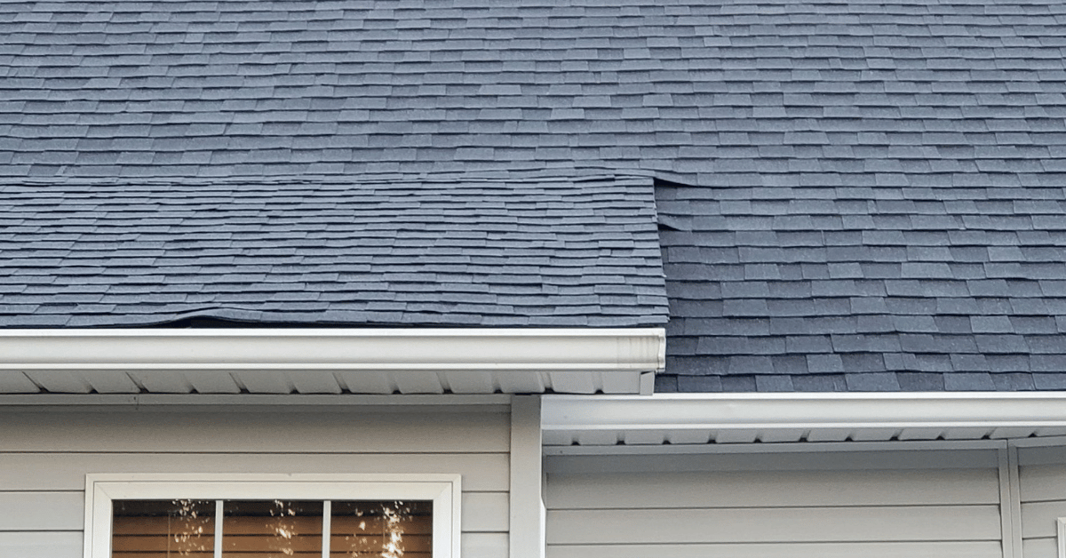 Sagging area on a residential roof indicating possible deck damage