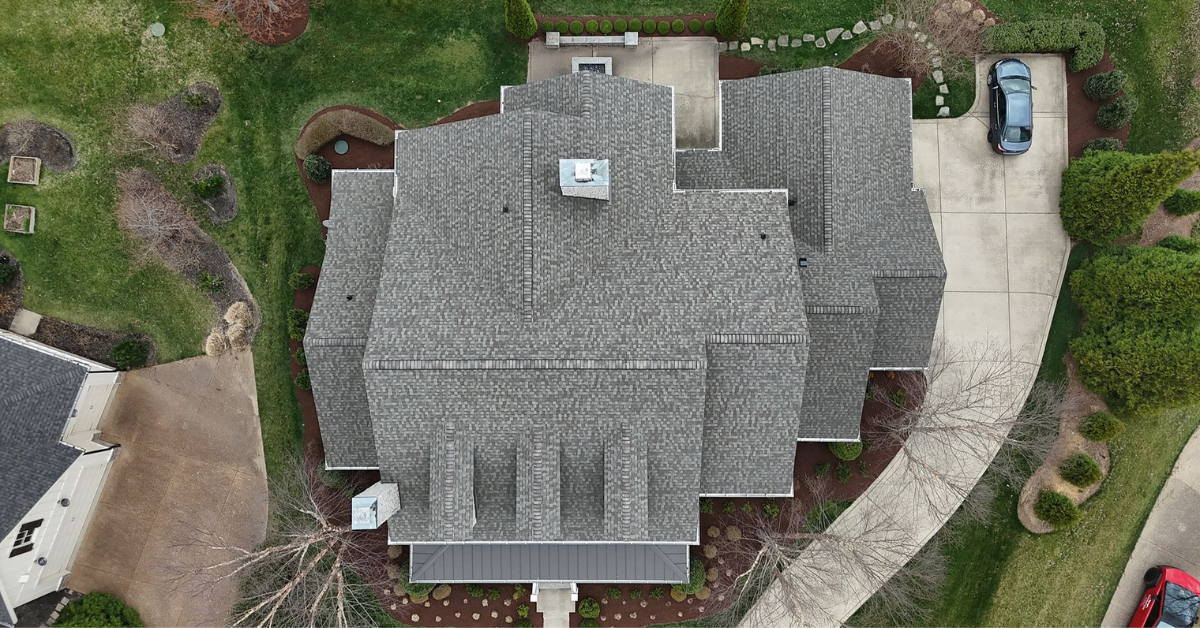 Top-down drone photo showing clean lines and uniform shingle installation on a large home, completed by expert local roofers in Franklin.