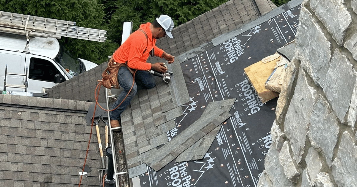 A Five Points Roofing technician installing new asphalt shingles over high-performance underlayment for long-term roof protection.