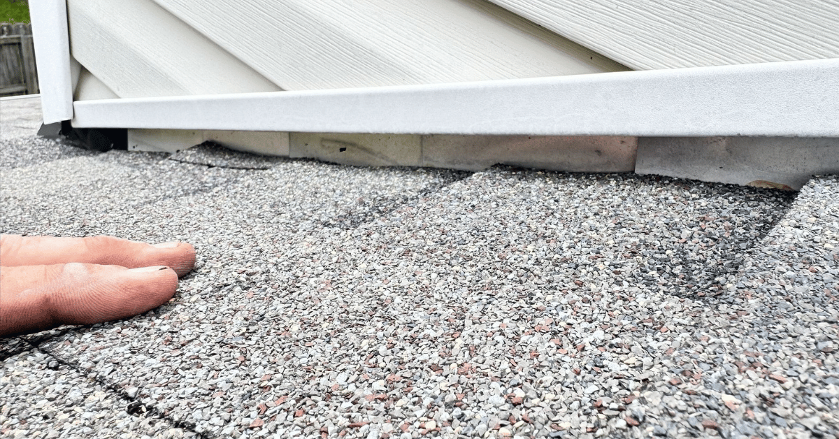 Evidence of improper installation techniques at roof flashing, potentially covered under a contractor's workmanship warranty or material warranty.