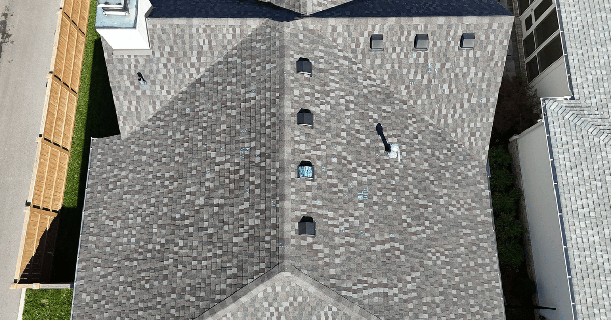Aerial view of an entire roof with inspection markings showing hail strikes, part of a storm damage roof inspection process for insurance documentation.