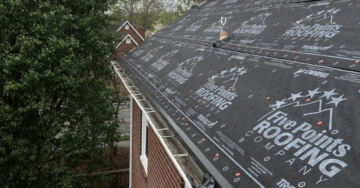 Premium synthetic roof underlayment branded with Five Points Roofing Company logo, installed on clean decking during a full roof replacement.