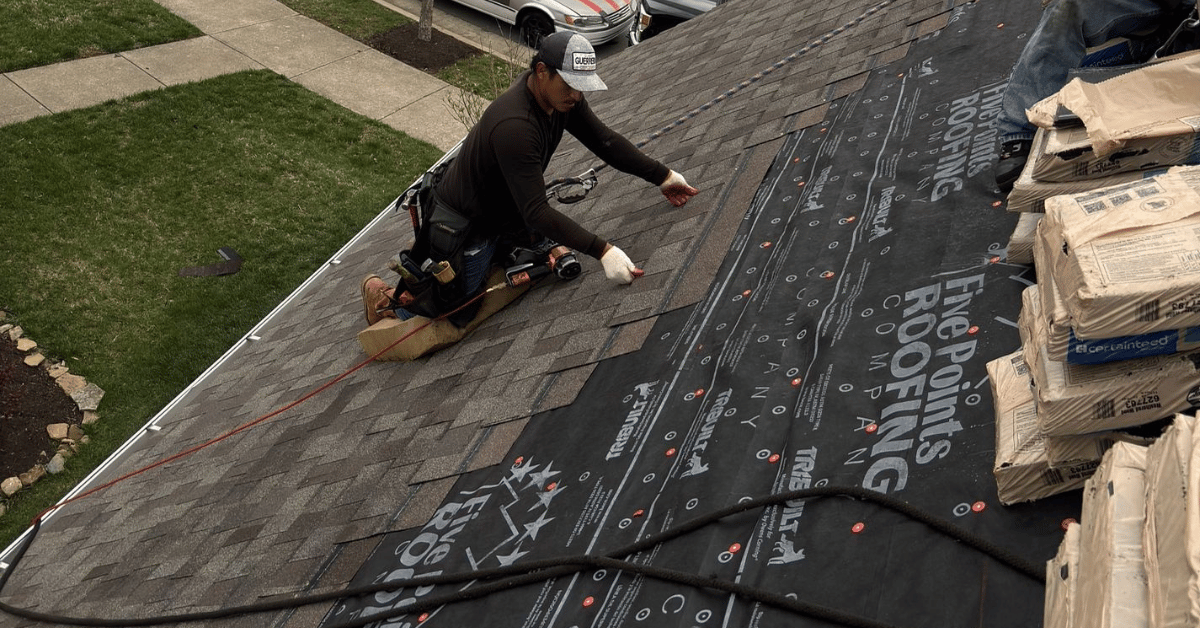 Roofing contractor from Five Points Roofing installing a new roofing system over synthetic underlayment during a full tear off and roof replacement.