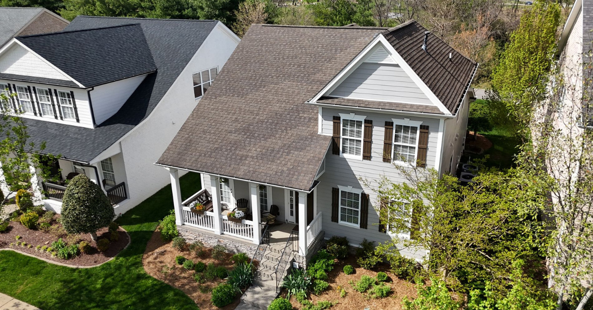 Drone-captured aerial image of a residential roof showing moderate shingle aging and summer discoloration.