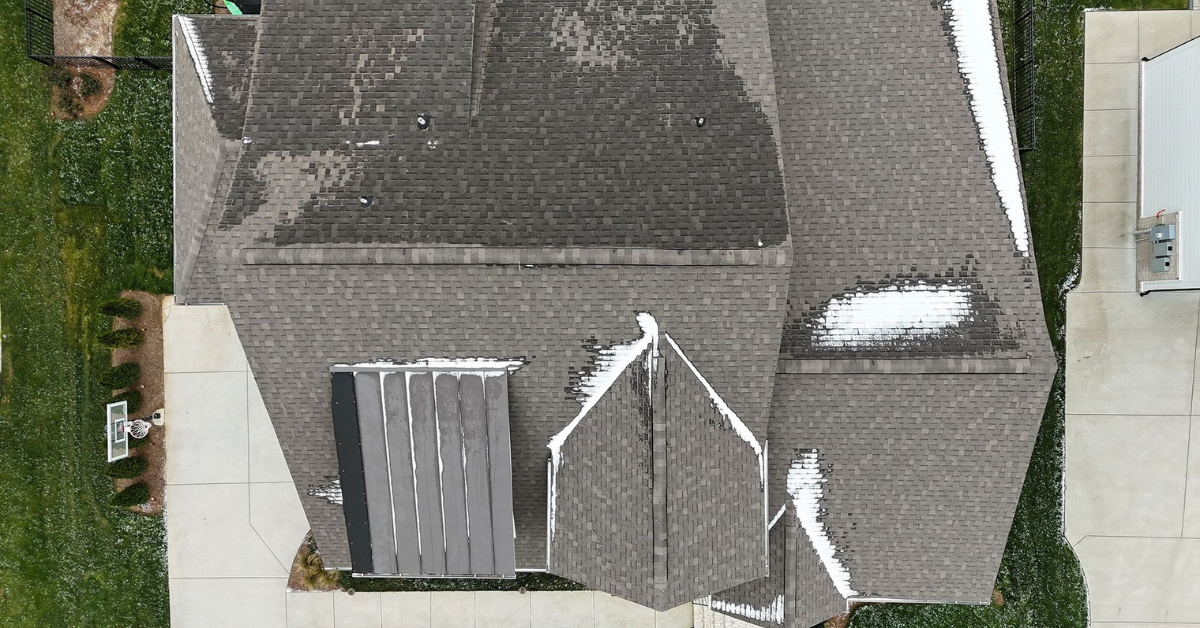 Drone image of residential roof with snow accumulation highlighting winter weather wear on Middle Tennessee homes