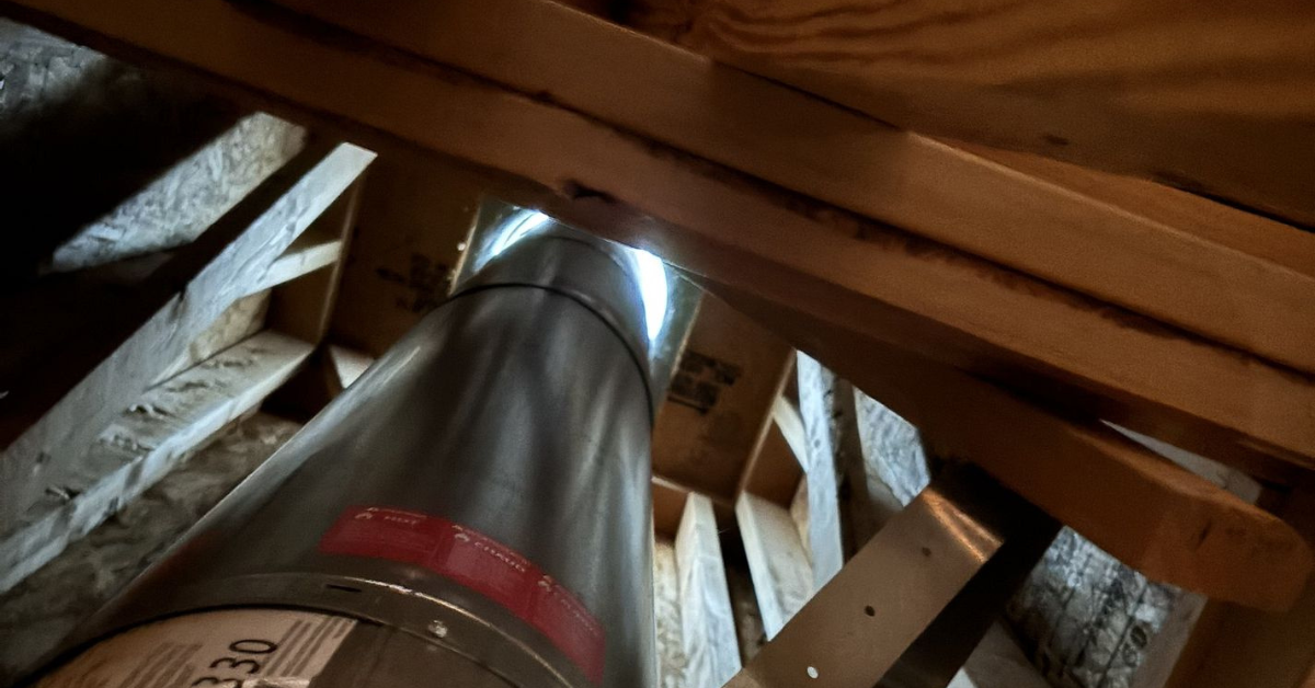 Metal attic ventilation ductwork allowing hot air to escape and reduce temperature buildup in the attic during summer months.