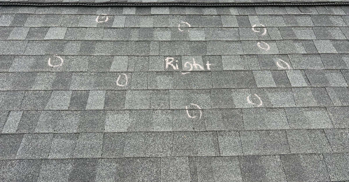 Roof shingles marked with chalk circles highlighting hail damage found during inspection for insurance claim