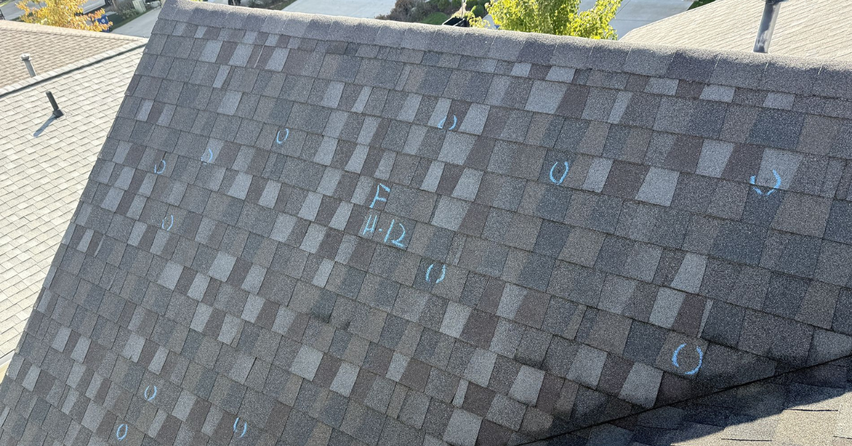 A roof with chalk circles marking hail impacts, a common method used by roofing inspectors to identify hail damage.