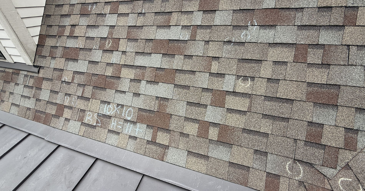 Roof with chalk circles and measurement markings identifying multiple hail strikes for documentation and claim purposes.