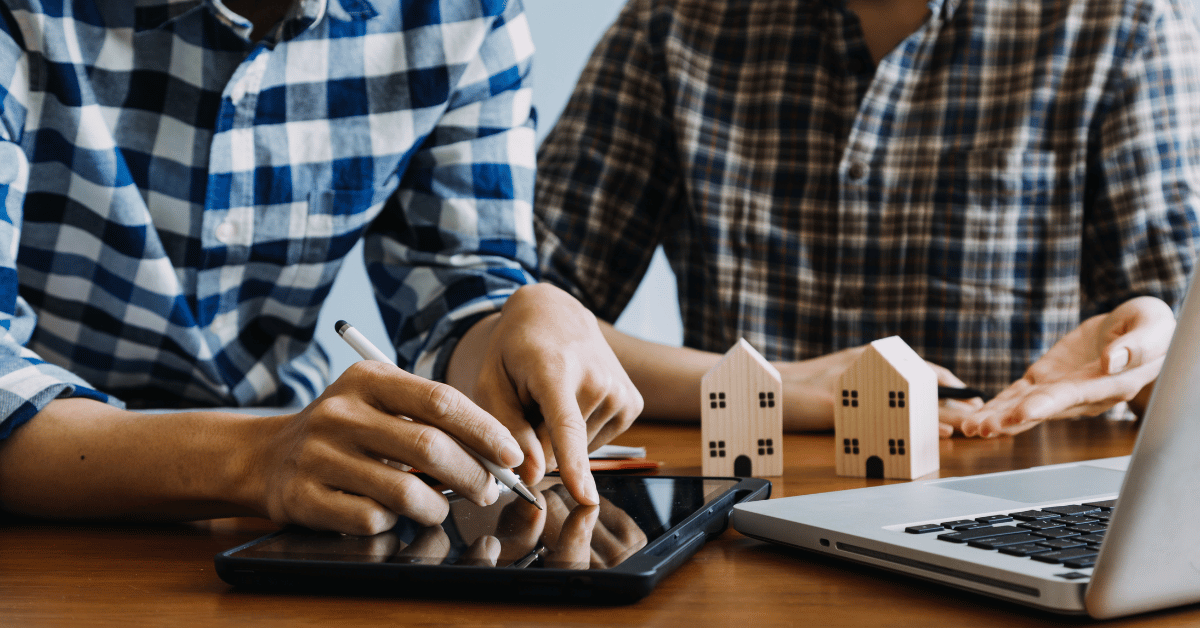 Couple examining their home insurance policy details before filing a roof insurance claim.