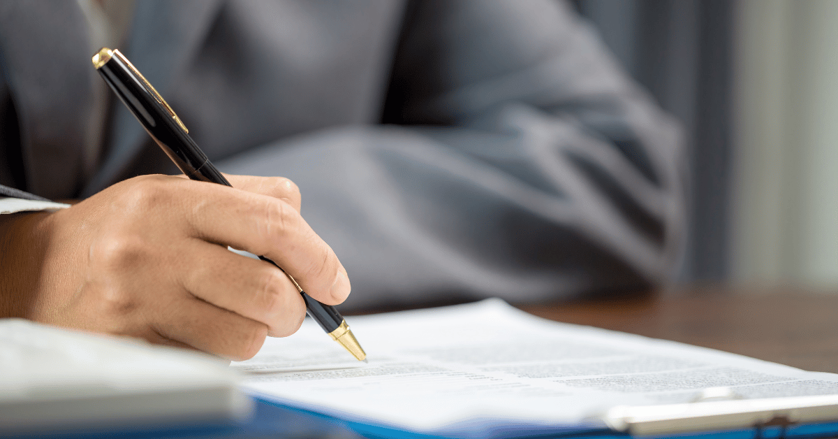 A homeowner signs paperwork for a roof insurance claim, a key step in the home insurance claims process.